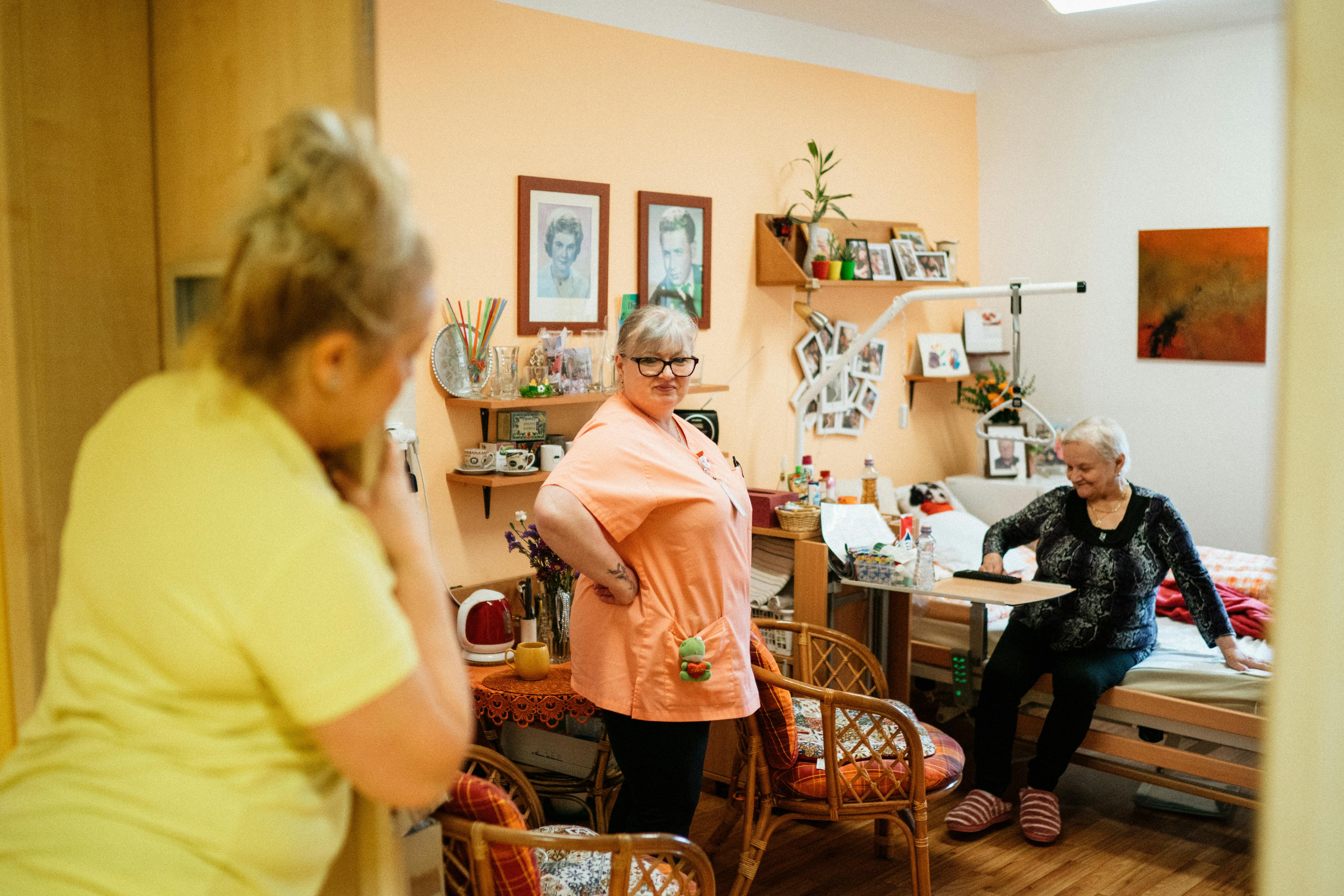 A caregiver and family connecting warmly with a senior at home.