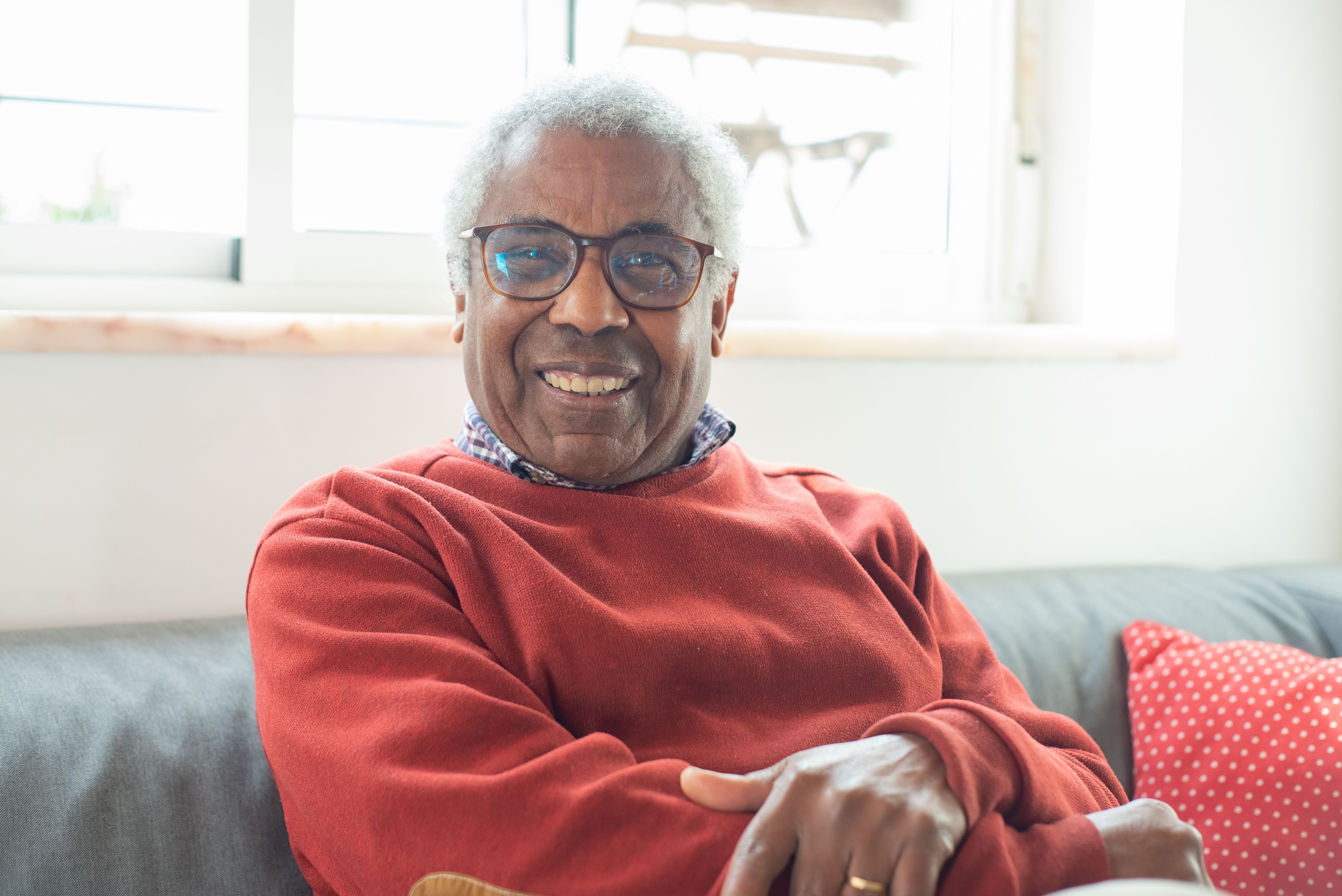 A smiling senior at home, relaxed and well cared for.