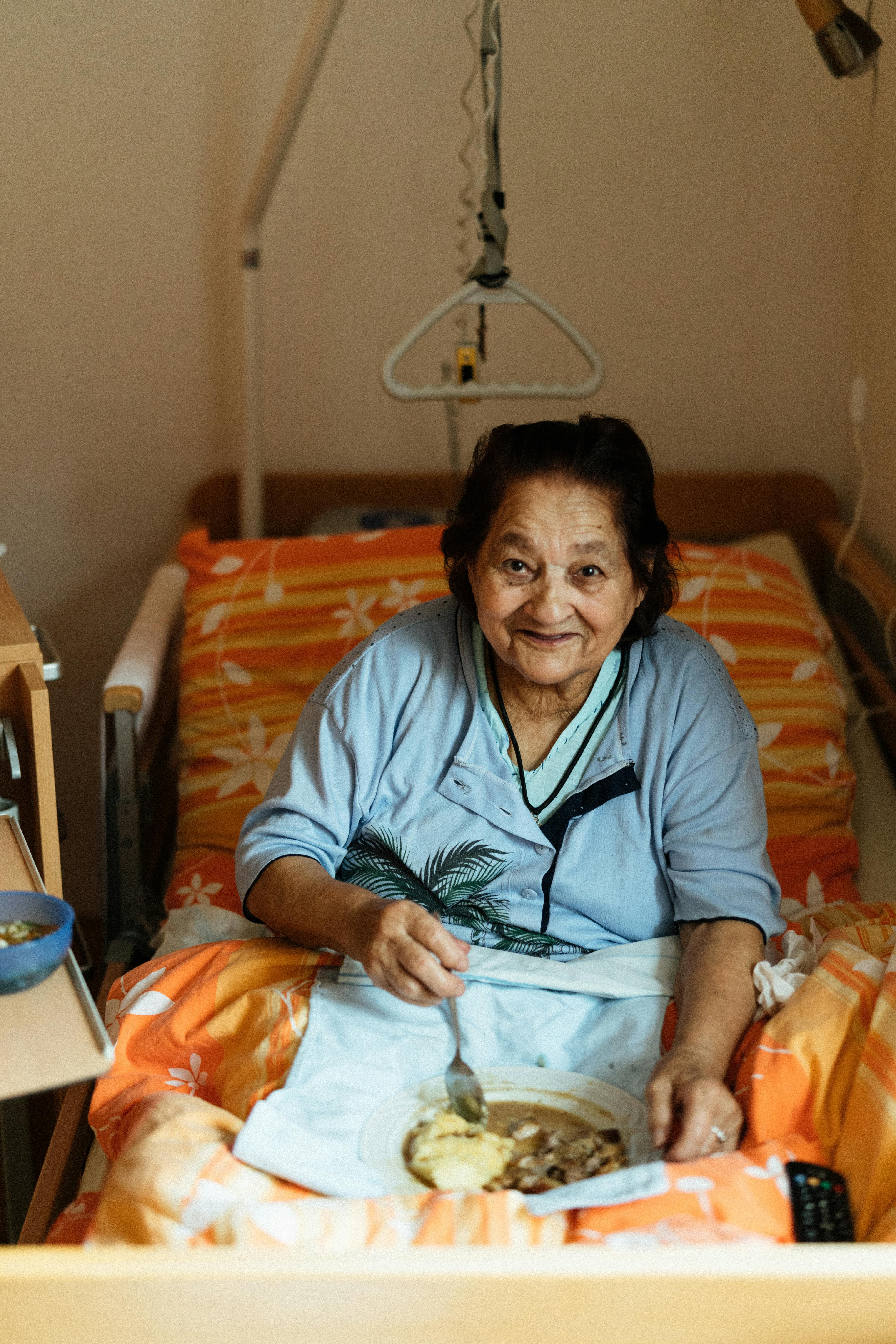 An older parent at home, family quietly informed from afar.